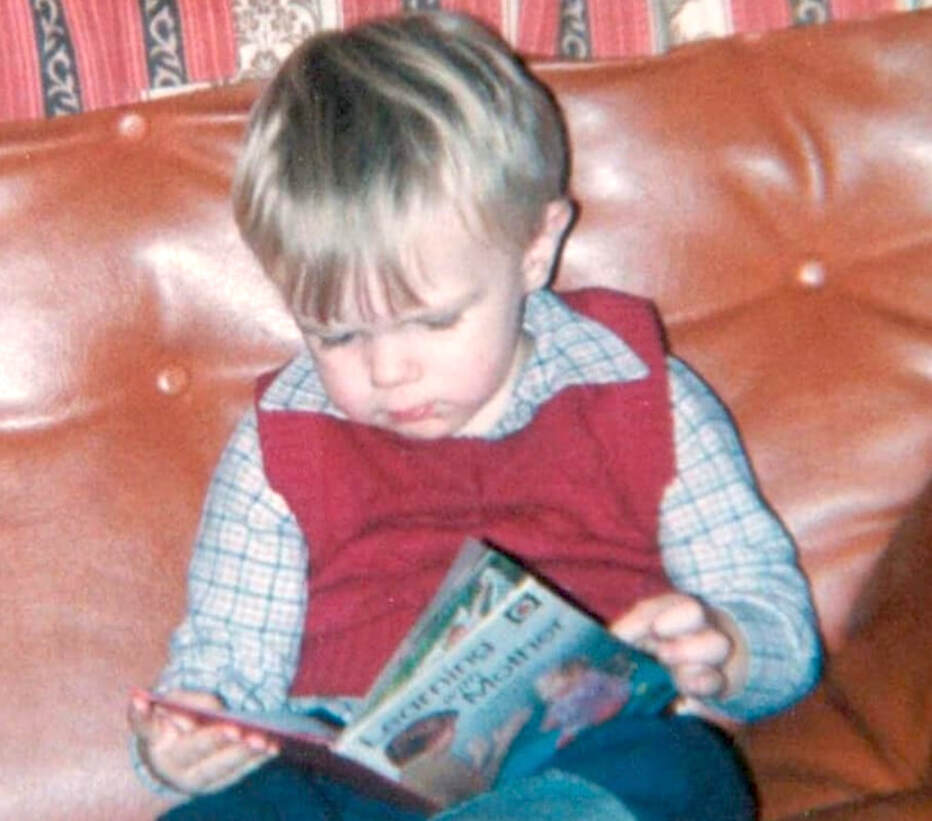 Rich Sutherland as a young child, reading a Ladybird book