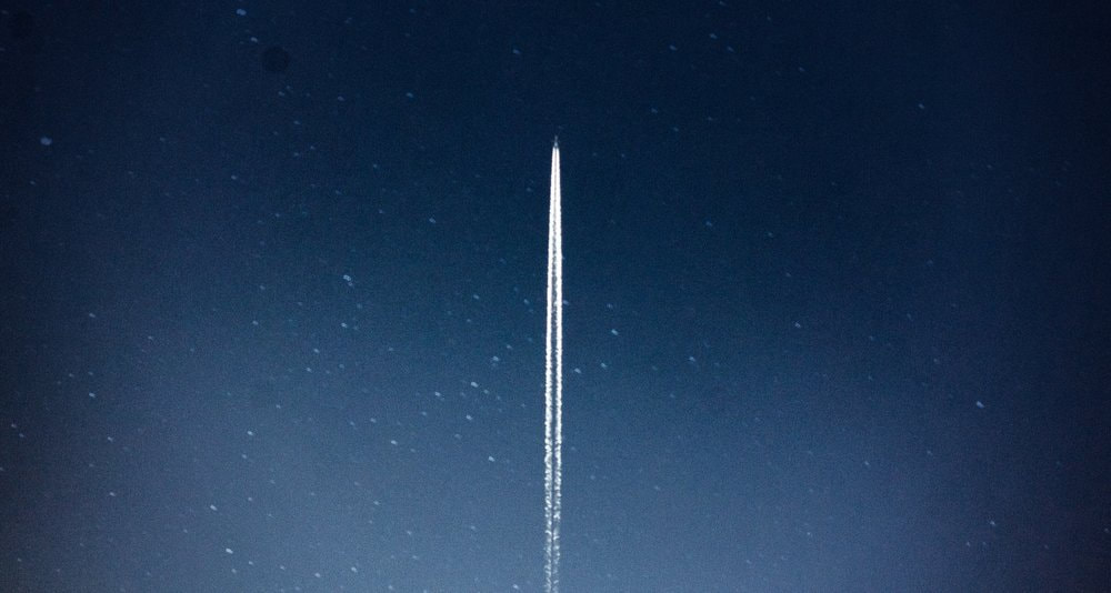 A distant space rocket heading towards space.